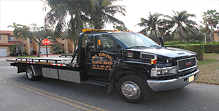 Flat bed J&S towing service truck